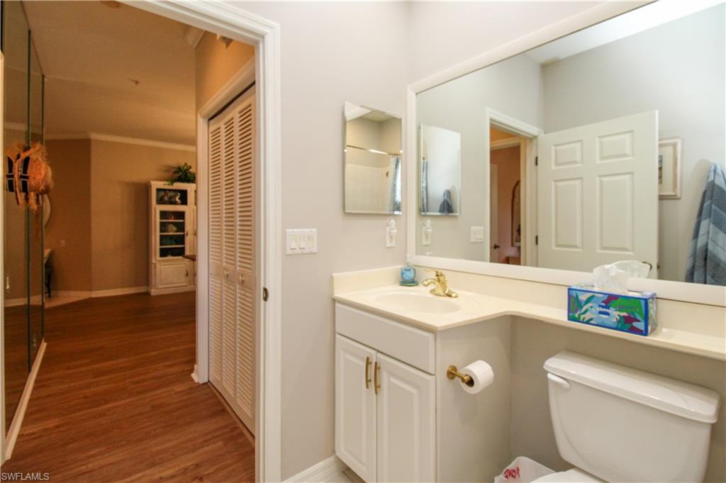 8488 Radcliffe Terrace, Unit 104 Naples, FL 34120 - Photo 36 of 50 a bathroom with a sink and a mirror