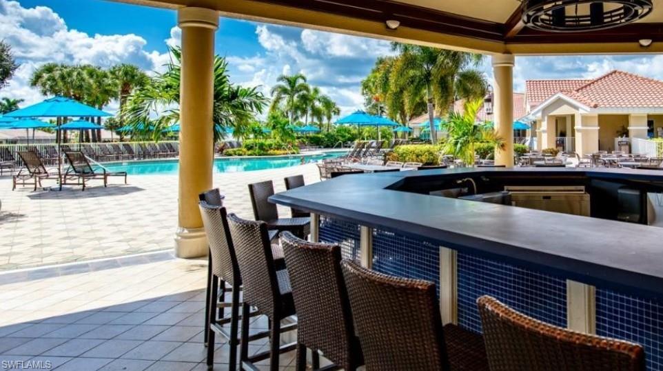 8488 Radcliffe Terrace, Unit 104 Naples, FL 34120 - Photo 45 of 50 a view of a patio with a table chairs and a table