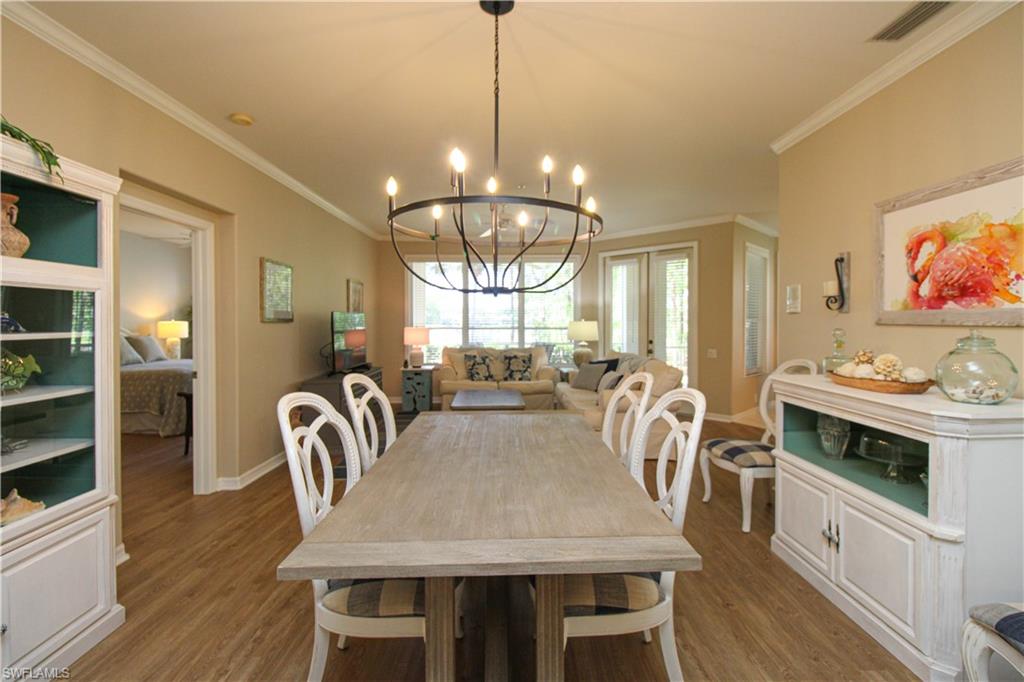 8488 Radcliffe Terrace, Unit 104 Naples, FL 34120 - Photo 8 of 50 a view of a dining room with furniture window and wooden floor