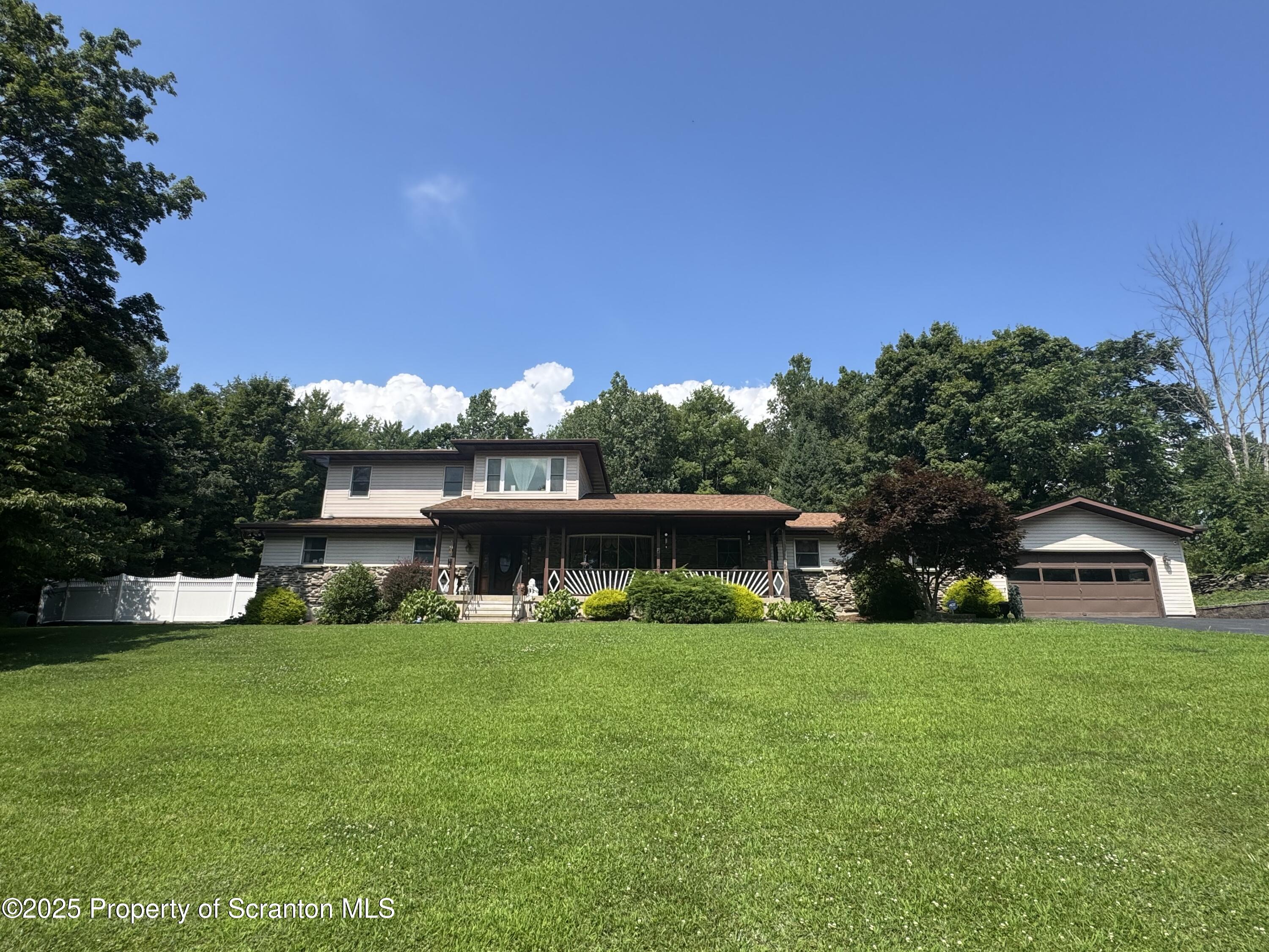 a view of a house with a yard porch and sitting area