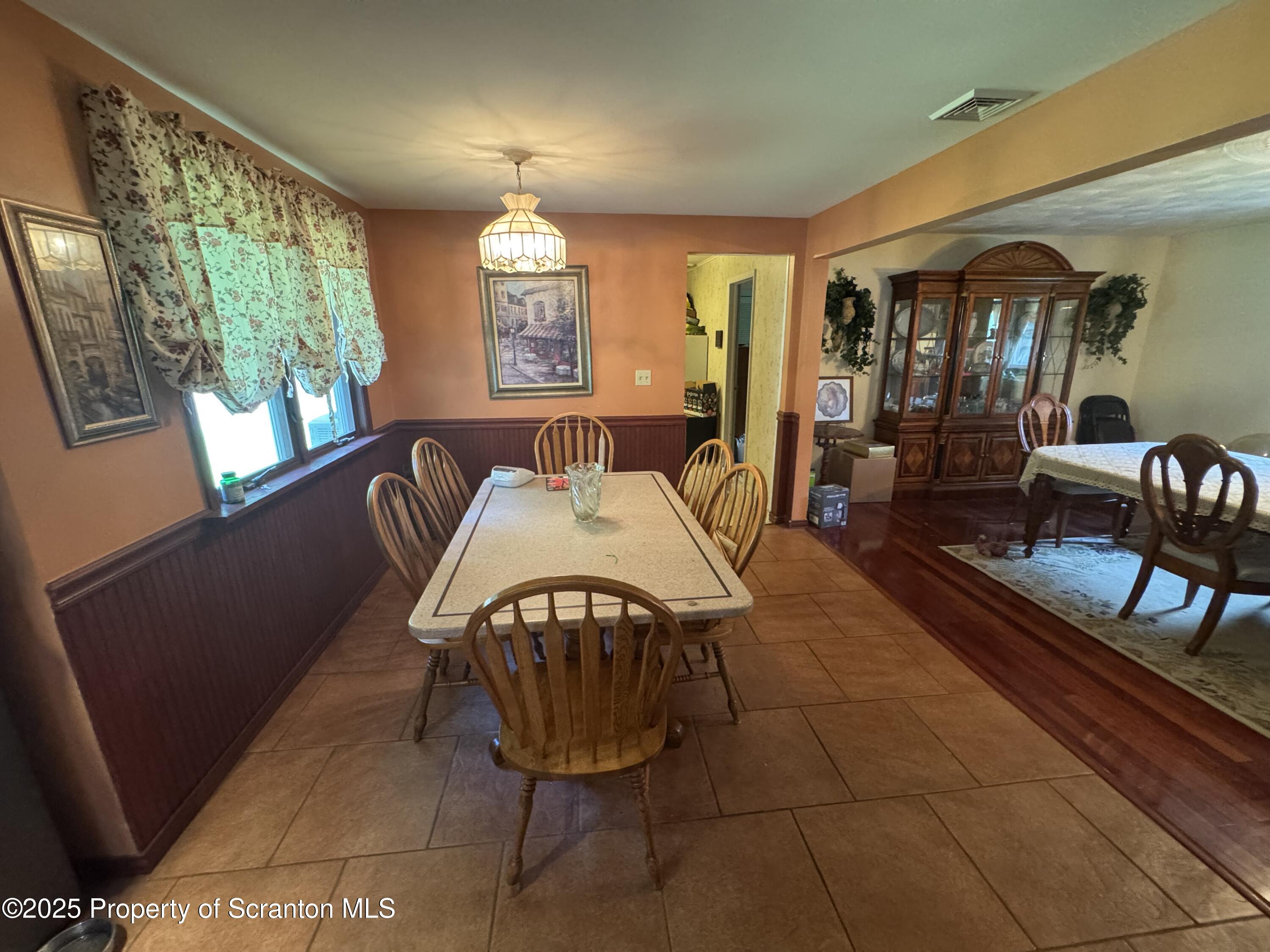 180 Savage Road Nicholson, PA 18446 - Photo 11 of 39 a living room with furniture a window and a flat screen tv