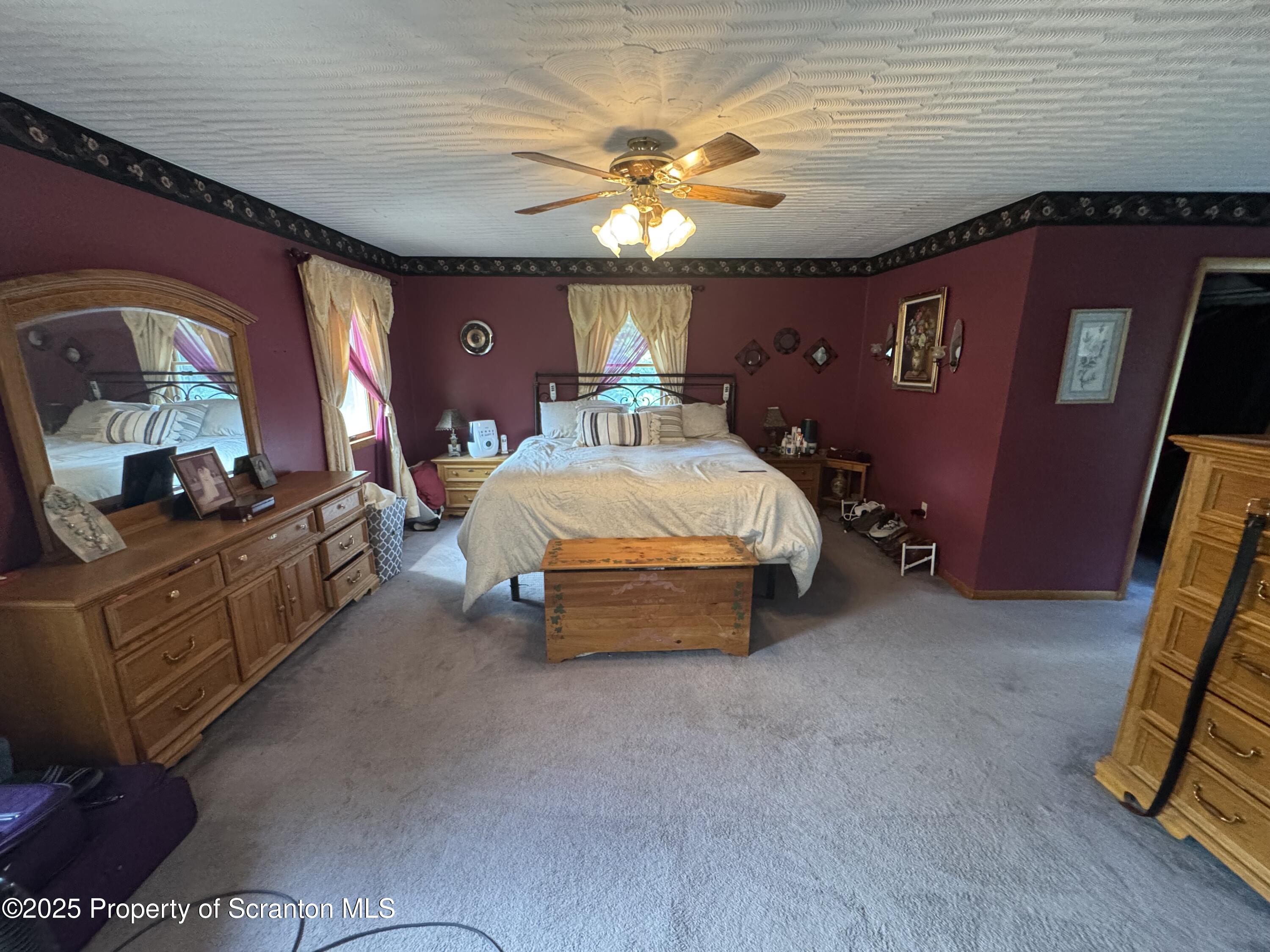 180 Savage Road Nicholson, PA 18446 - Photo 17 of 39 a bed room with a bed and a chandelier