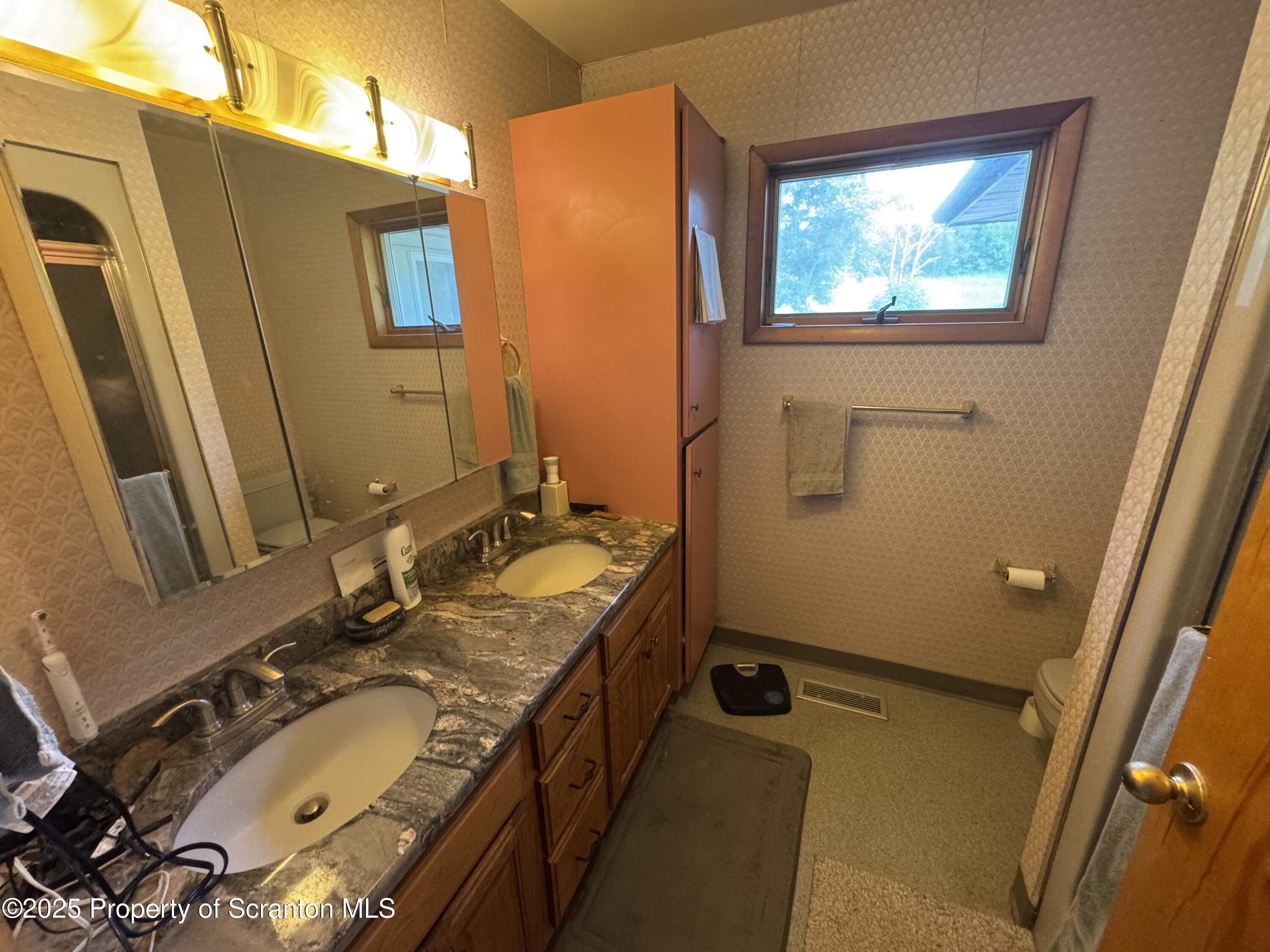 180 Savage Road Nicholson, PA 18446 - Photo 18 of 39 a bathroom with a granite countertop sink and a mirror
