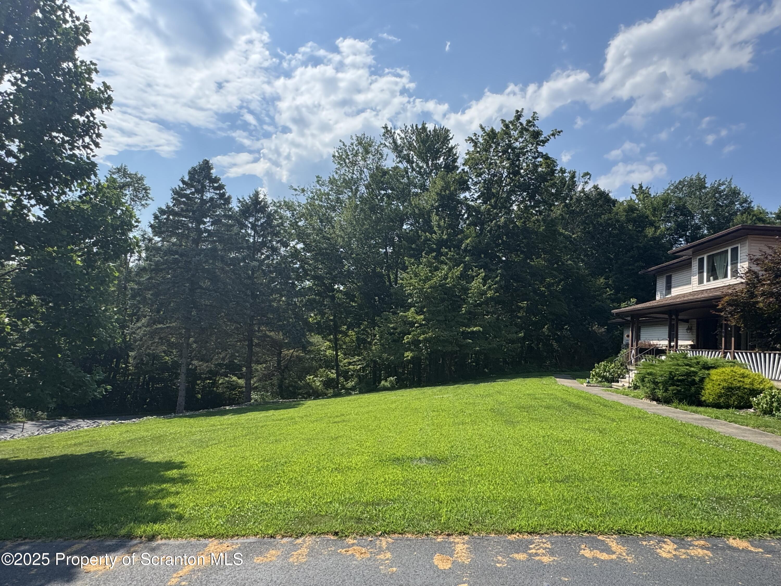 180 Savage Road Nicholson, PA 18446 - Photo 36 of 39 a view of a garden with a building in the background