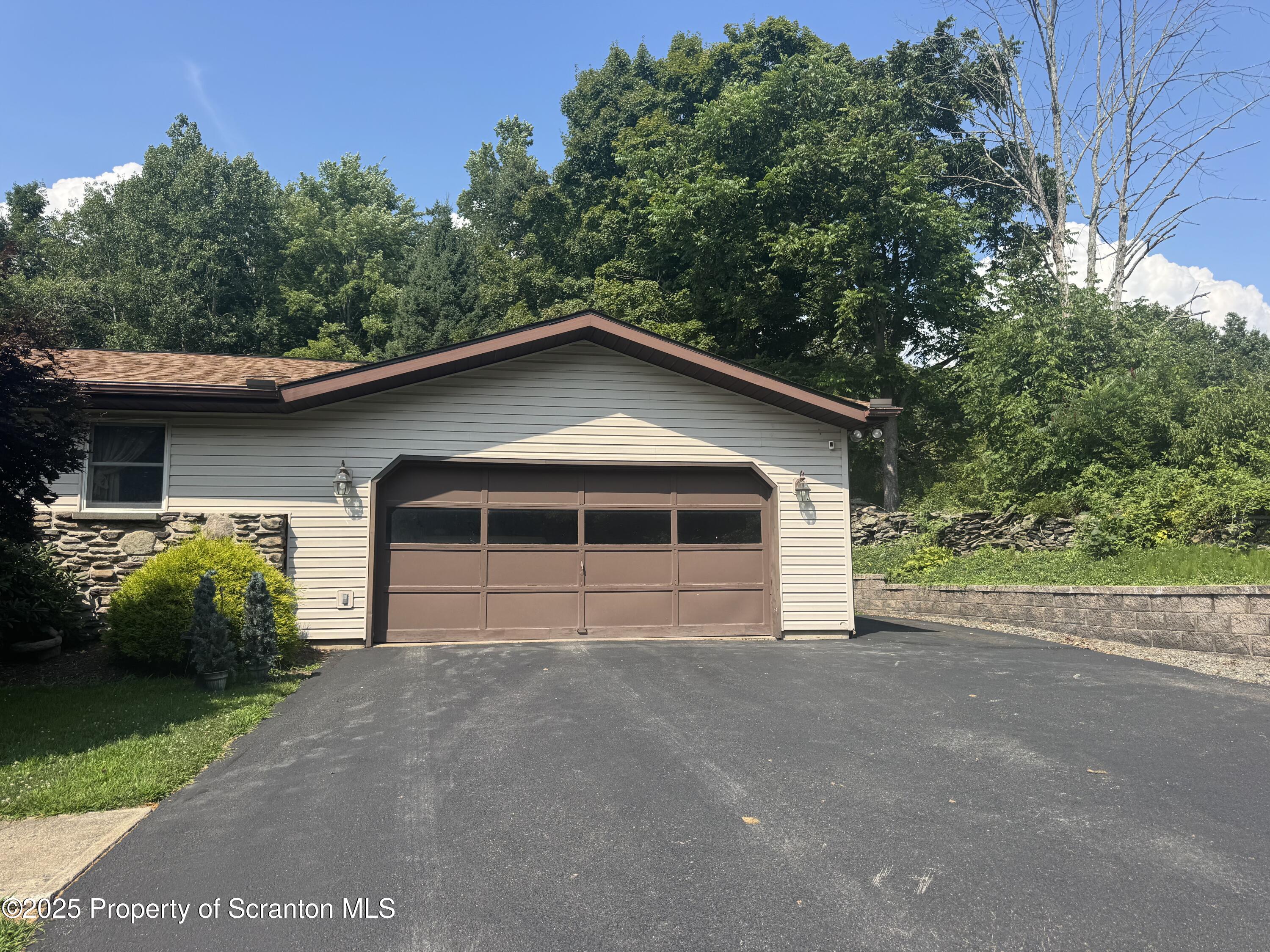 180 Savage Road Nicholson, PA 18446 - Photo 37 of 39 a view of a house with a yard plants and large trees