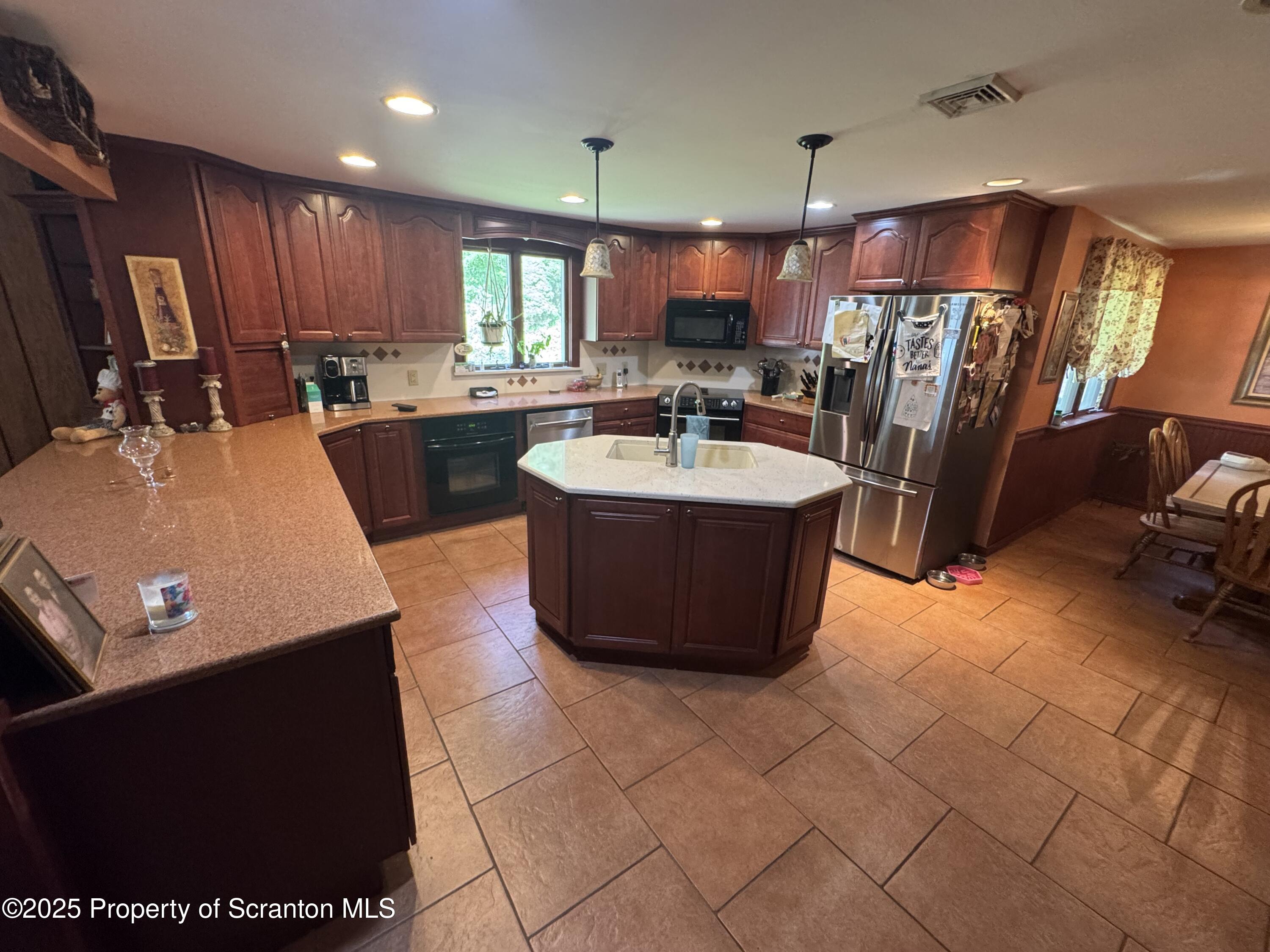 180 Savage Road Nicholson, PA 18446 - Photo 9 of 39 a large kitchen with lots of counter space a sink a refrigerator and chairs