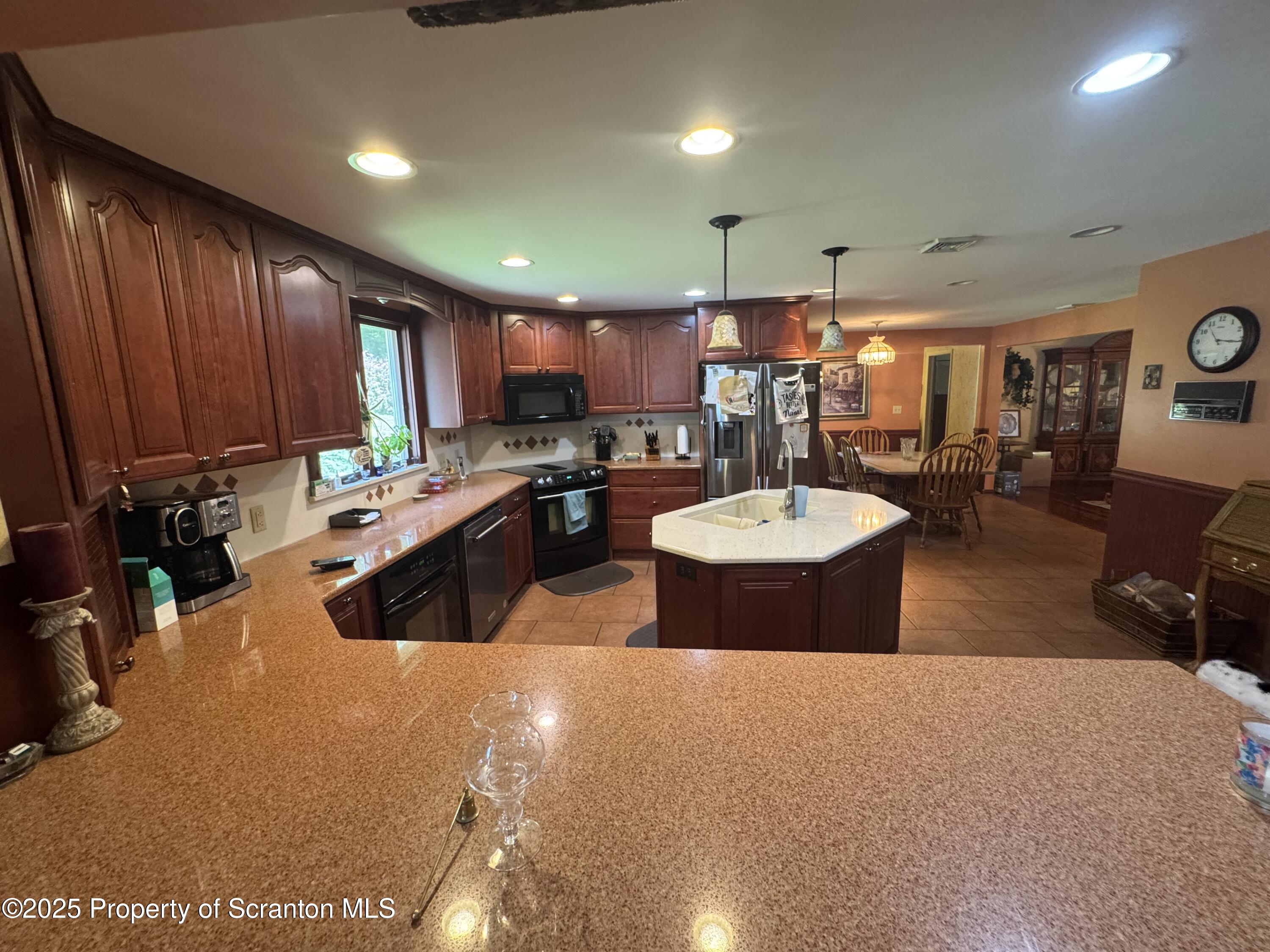 180 Savage Road Nicholson, PA 18446 - Photo 10 of 39 a kitchen with a sink and a stove top oven with wooden floor