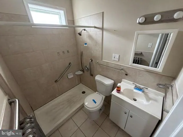 a bathroom with a granite countertop sink mirror and toilet