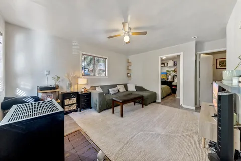 a living room with furniture and a chandelier