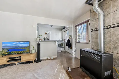 a kitchen with stainless steel appliances kitchen island granite countertop a stove and a refrigerator