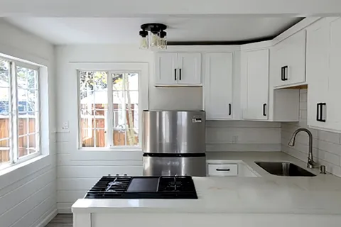a kitchen with a sink stove and cabinets