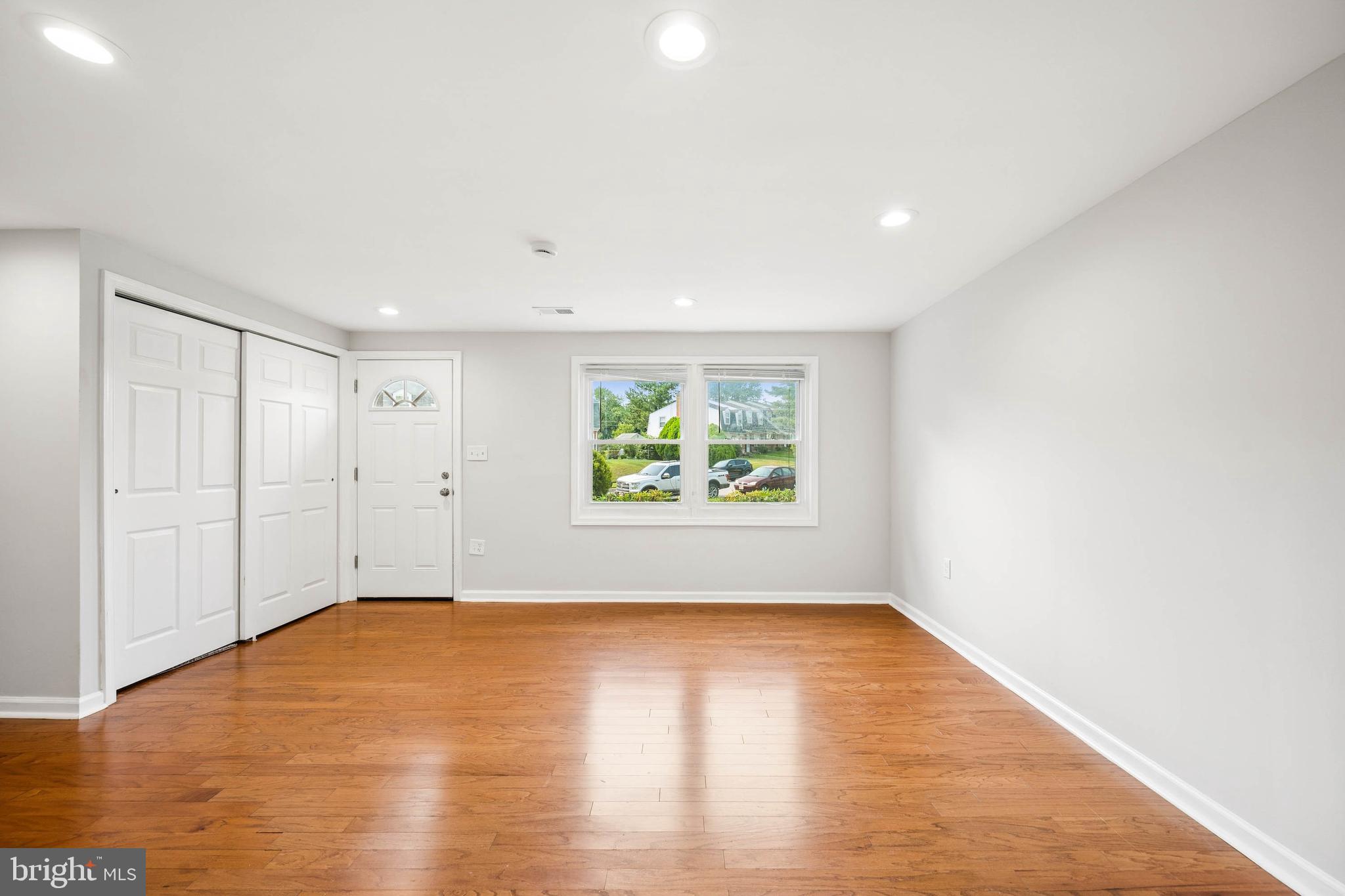 7227 Sindall Road Baltimore, MD 21234 - Photo 13 of 62 a view of an empty room with wooden floor and a window