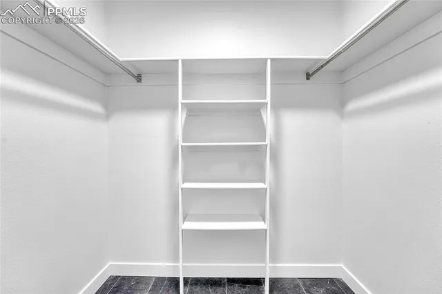 a view of an empty room and closet area