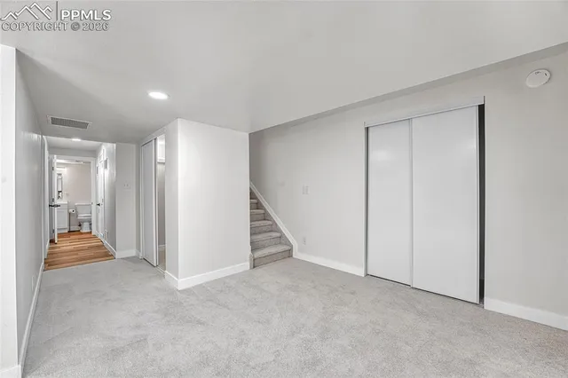 a view of an empty room with a fireplace