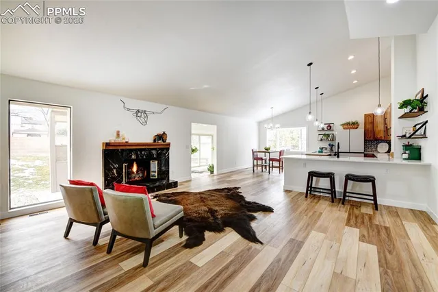 a living room with furniture and wooden floor