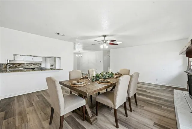 a dining room with furniture and wooden floor