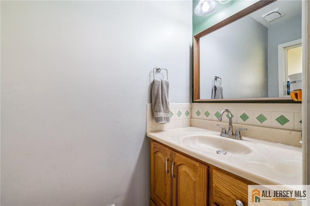 62 Laura Avenue Edison, NJ 08820 - Photo 15 of 35 a bathroom with a sink and a mirror