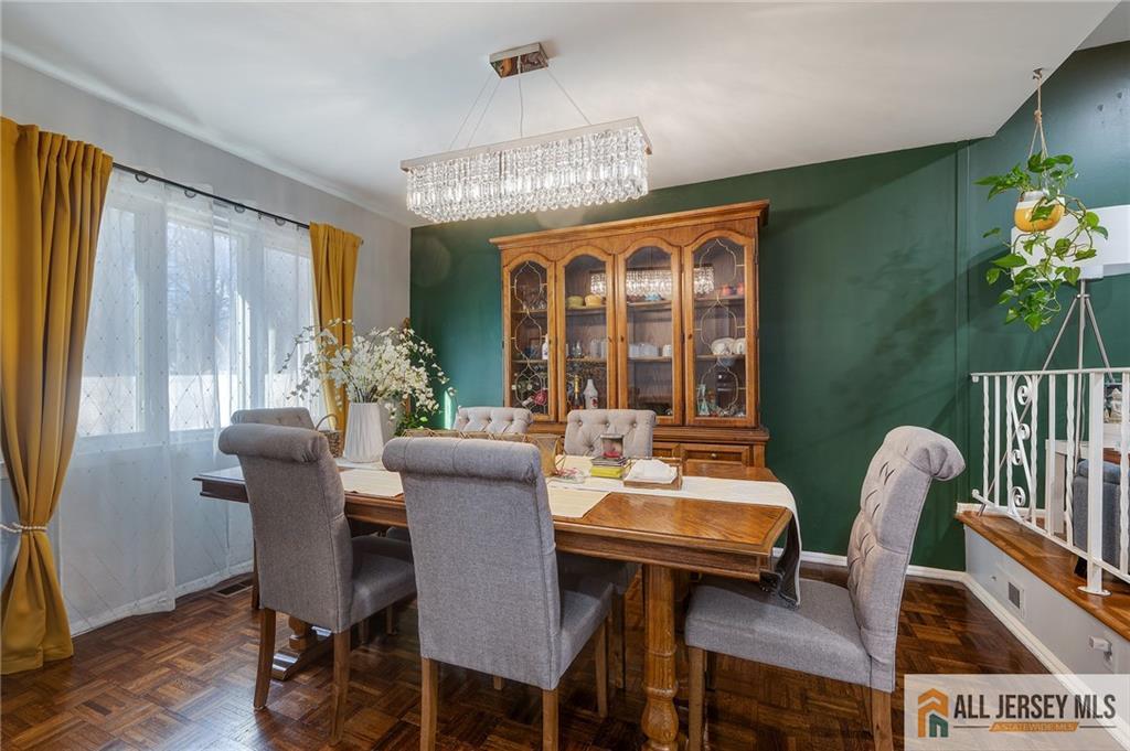62 Laura Avenue Edison, NJ 08820 - Photo 18 of 35 a dining room with furniture potted plants and wooden floor