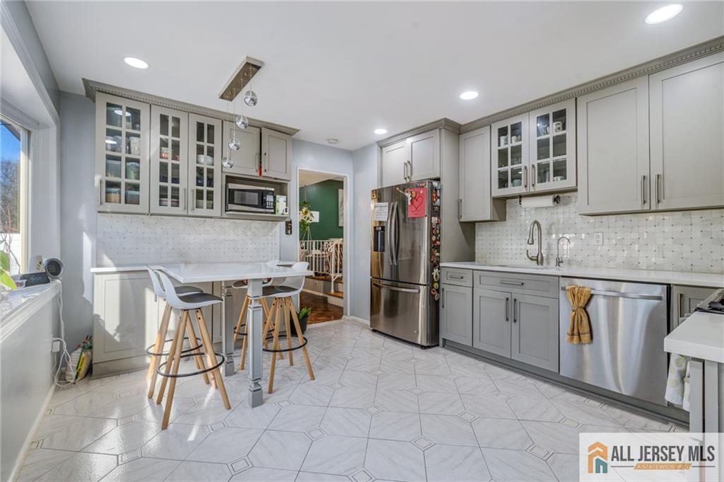 62 Laura Avenue Edison, NJ 08820 - Photo 19 of 35 a kitchen with cabinets and chairs