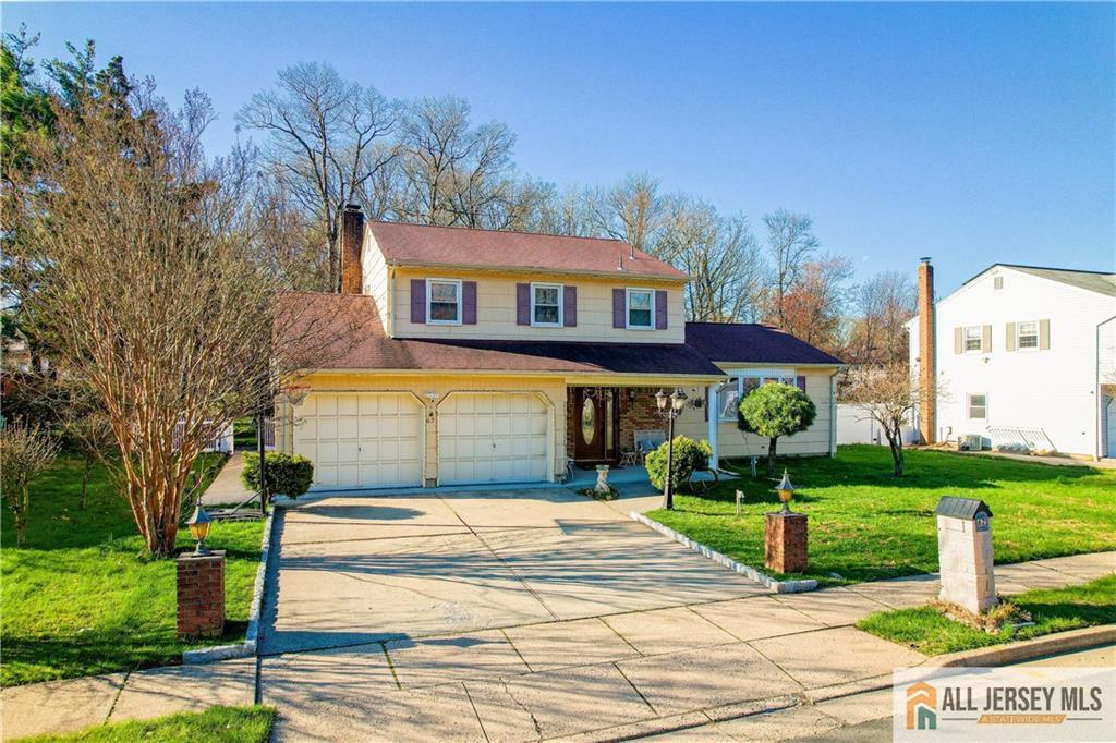62 Laura Avenue Edison, NJ 08820 - Photo 2 of 35 a front view of a house with a yard and potted plants