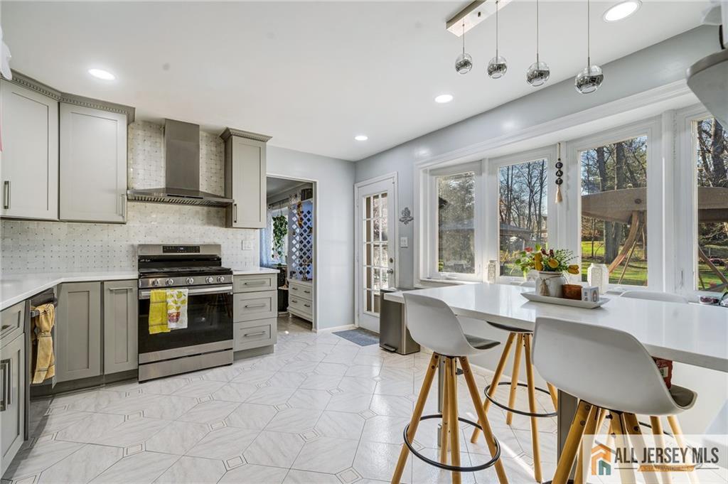 62 Laura Avenue Edison, NJ 08820 - Photo 21 of 35 a kitchen with stainless steel appliances granite countertop a stove and a refrigerator