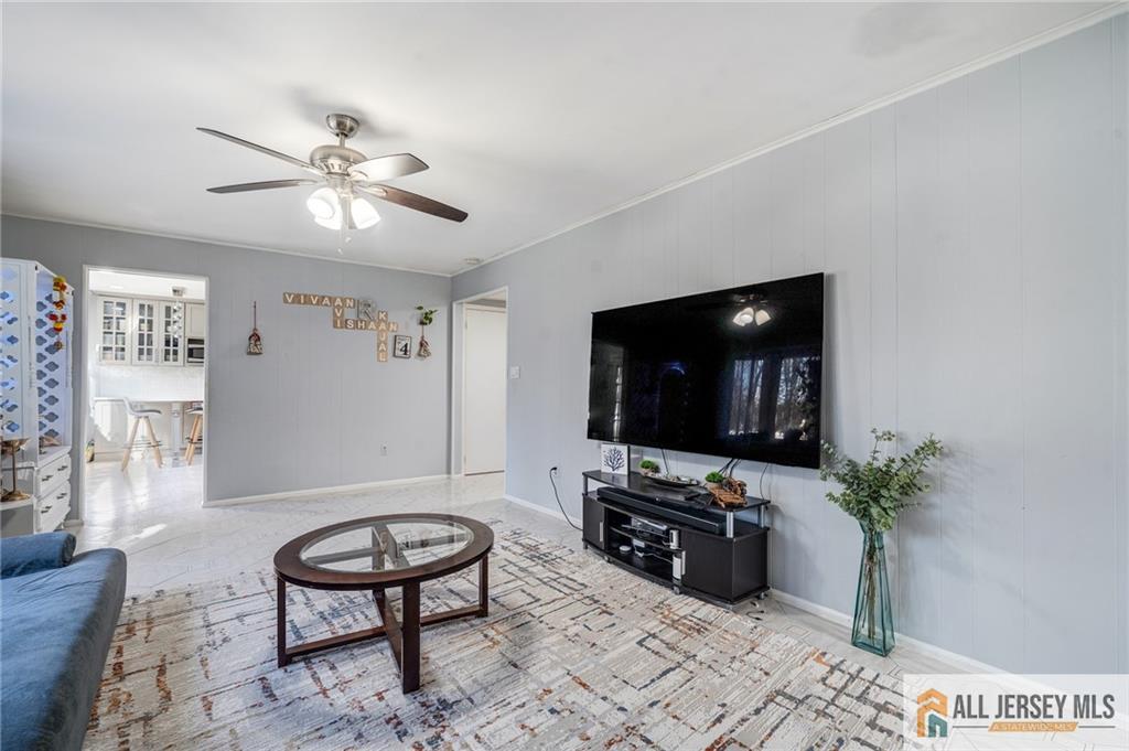 62 Laura Avenue Edison, NJ 08820 - Photo 23 of 35 a living room with furniture and a flat screen tv
