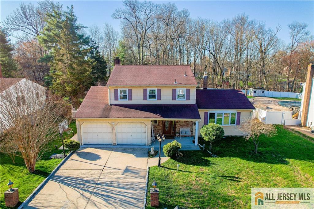 62 Laura Avenue Edison, NJ 08820 - Photo 3 of 35 a front view of a house with a yard and green space