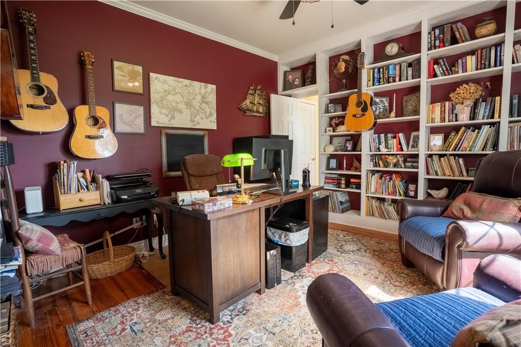 442 Buffalo Creek Road Carrollton, GA 30117 - Photo 20 of 39 a work room with furniture and book shelf