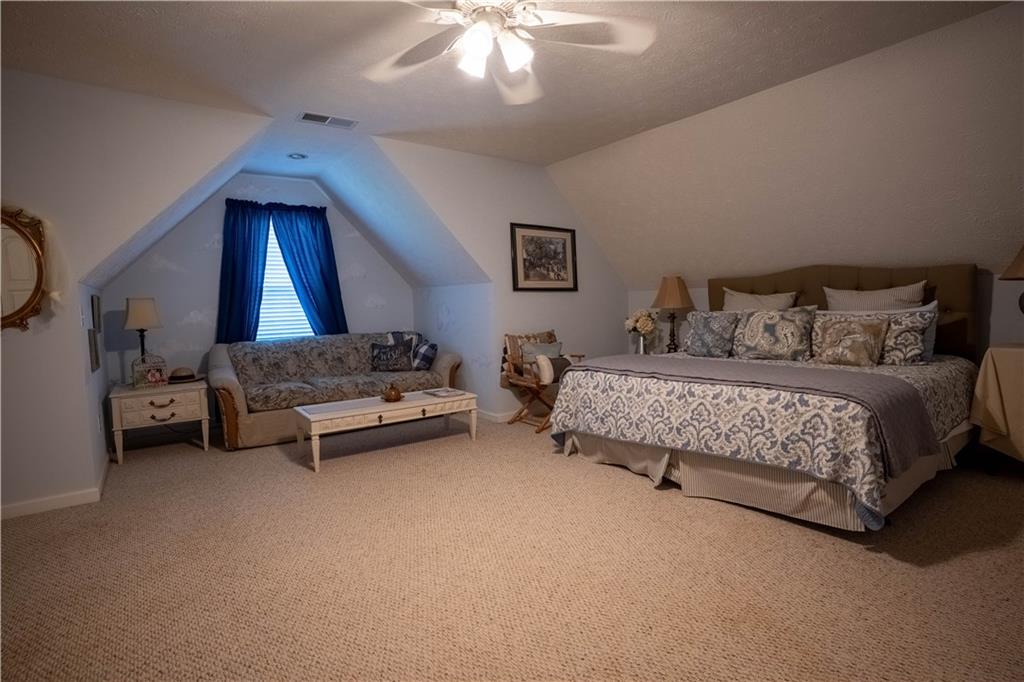 442 Buffalo Creek Road Carrollton, GA 30117 - Photo 23 of 39 a bedroom with furniture and a chandelier