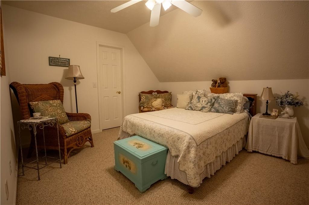442 Buffalo Creek Road Carrollton, GA 30117 - Photo 25 of 39 a bedroom with a bed and a ceiling fan