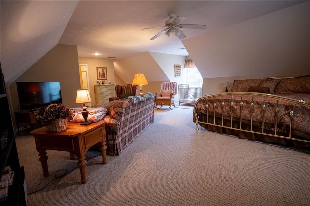 442 Buffalo Creek Road Carrollton, GA 30117 - Photo 27 of 39 a room with a bed a lamp and a flat screen tv
