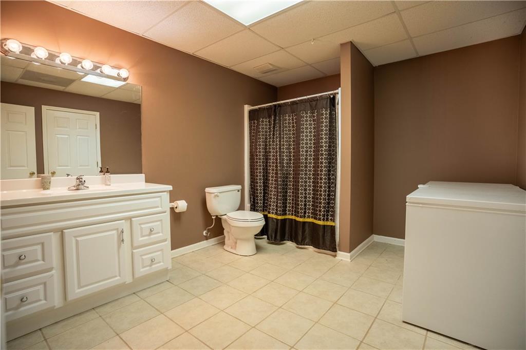442 Buffalo Creek Road Carrollton, GA 30117 - Photo 32 of 39 a spacious bathroom with a toilet sink and mirror
