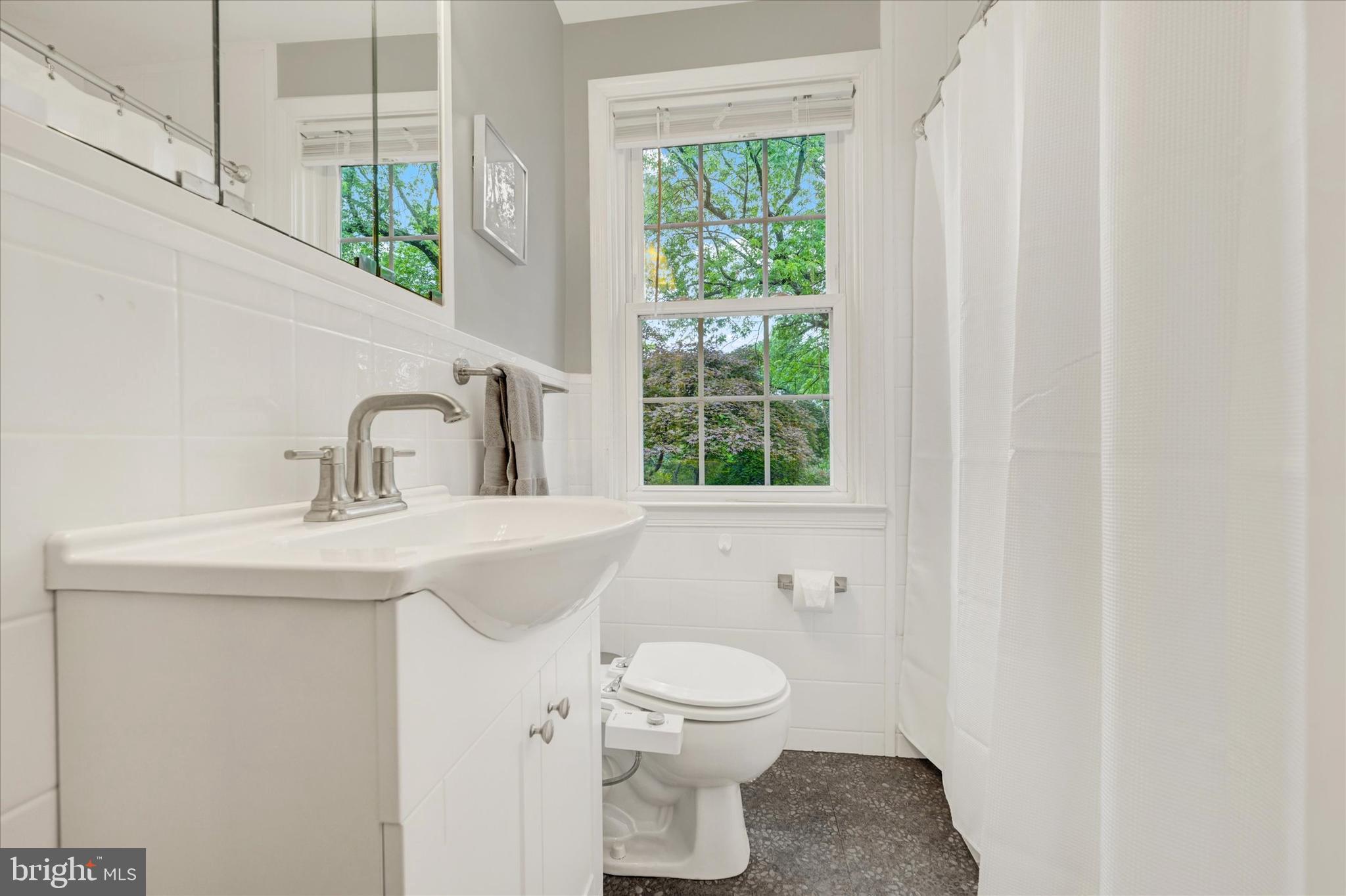 436 Old Trail Baltimore, MD 21212 - Photo 17 of 32 a bathroom with a toilet a sink and a window