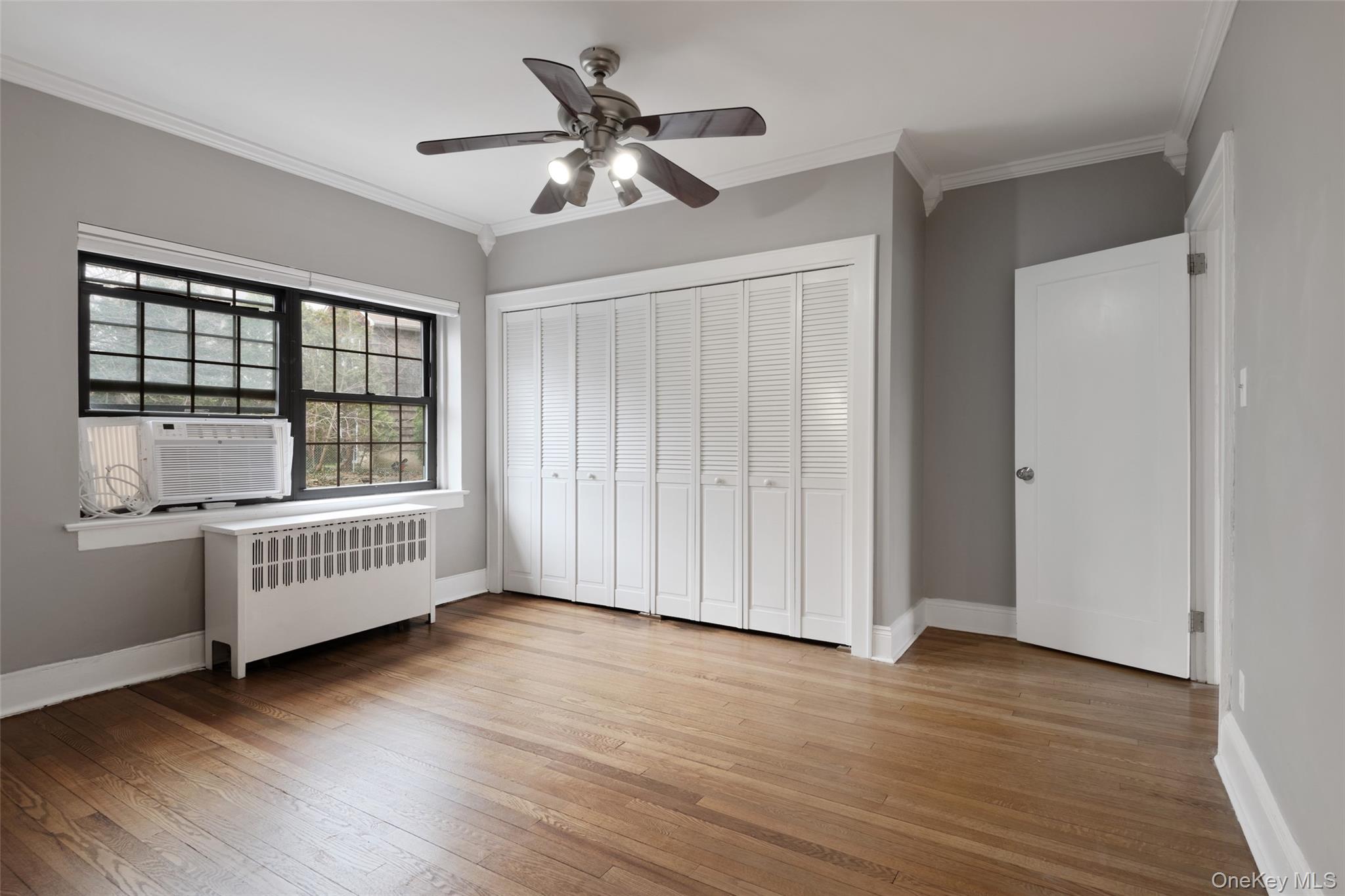 1444 Boston Post Road, Unit 2G Larchmont, NY 10538 - Photo 12 of 15 wooden floor in an empty room with a window