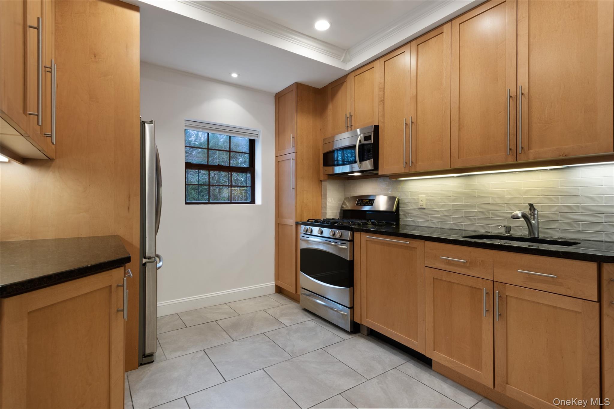 1444 Boston Post Road, Unit 2G Larchmont, NY 10538 - Photo 5 of 15 a kitchen with stainless steel appliances granite countertop a sink and cabinets