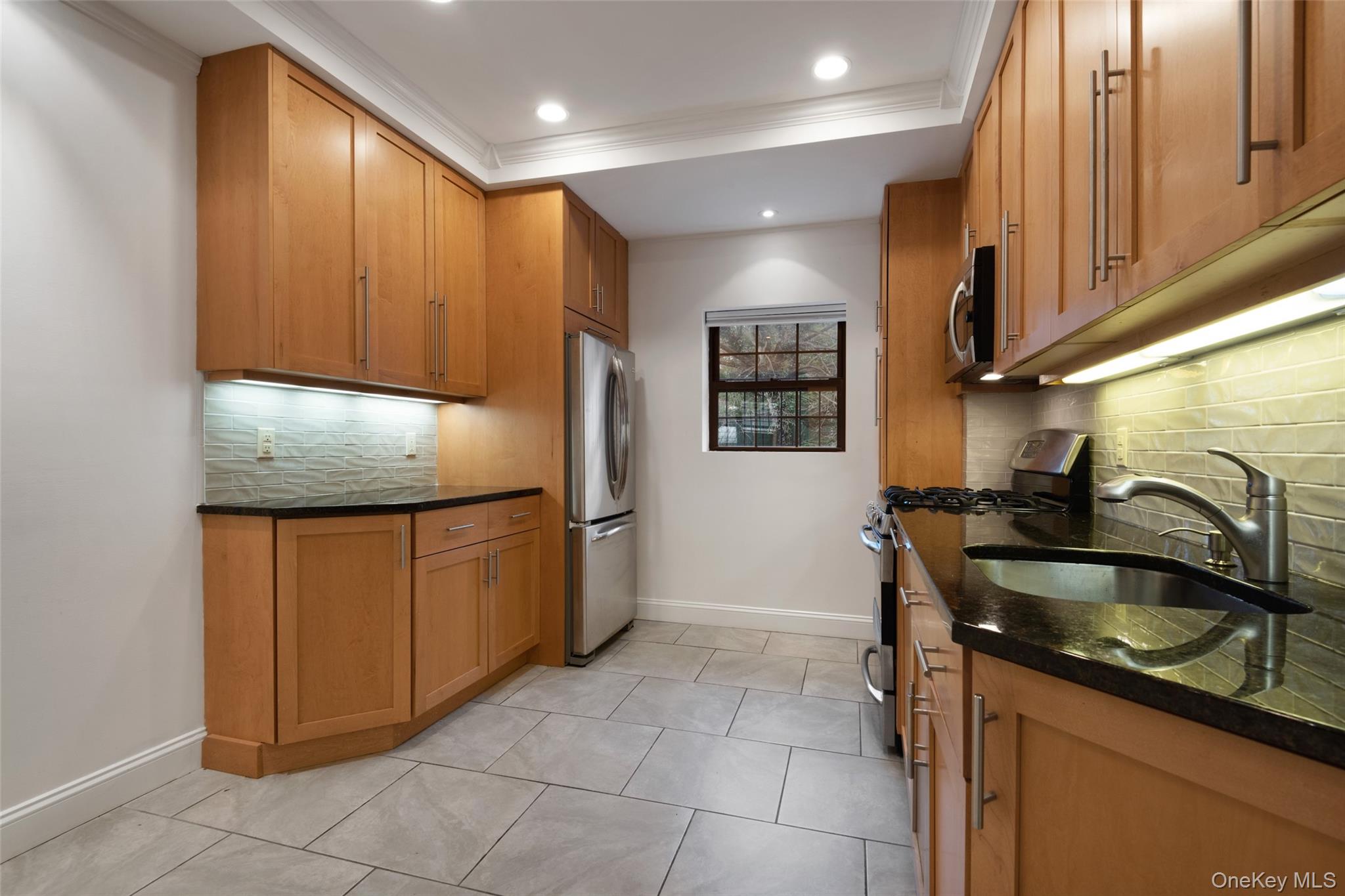 1444 Boston Post Road, Unit 2G Larchmont, NY 10538 - Photo 6 of 15 a kitchen with stainless steel appliances granite countertop a sink stove and refrigerator