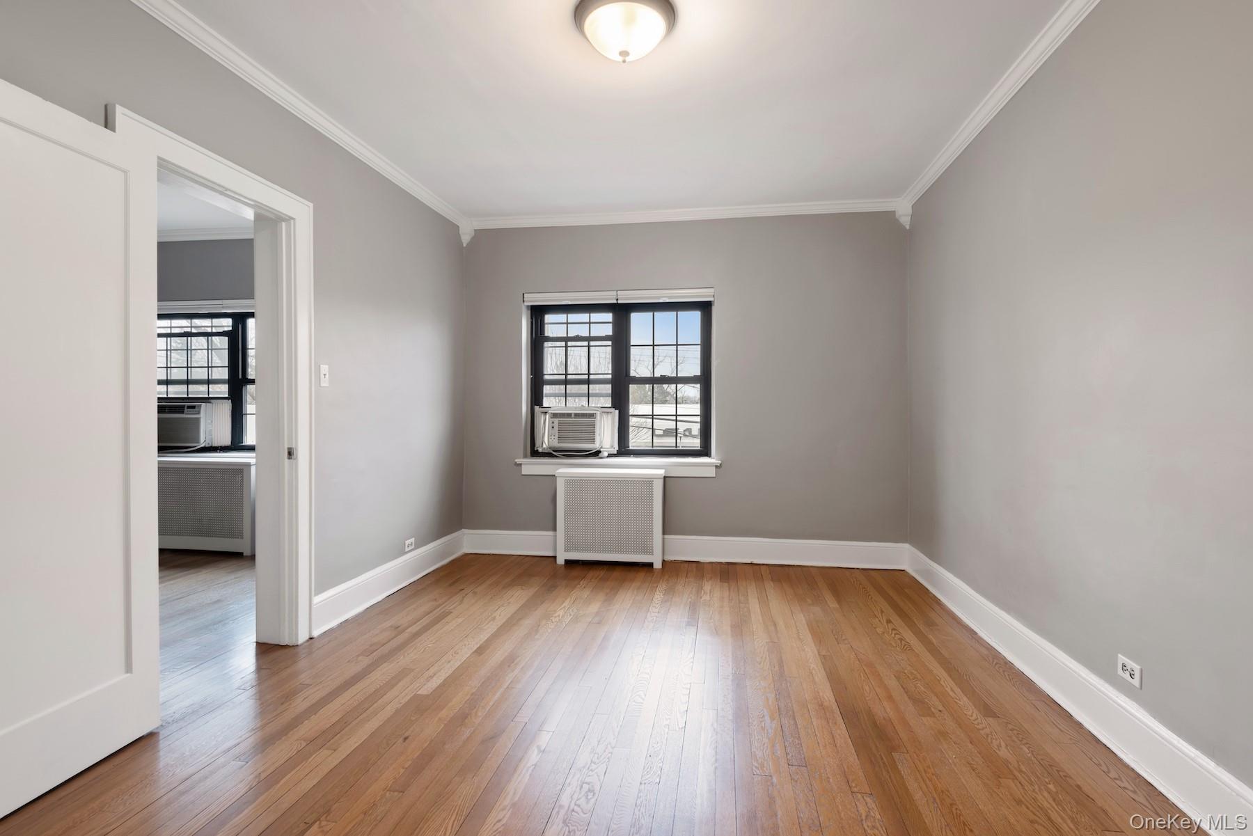 1444 Boston Post Road, Unit 2G Larchmont, NY 10538 - Photo 9 of 15 wooden floor in an empty room with a window