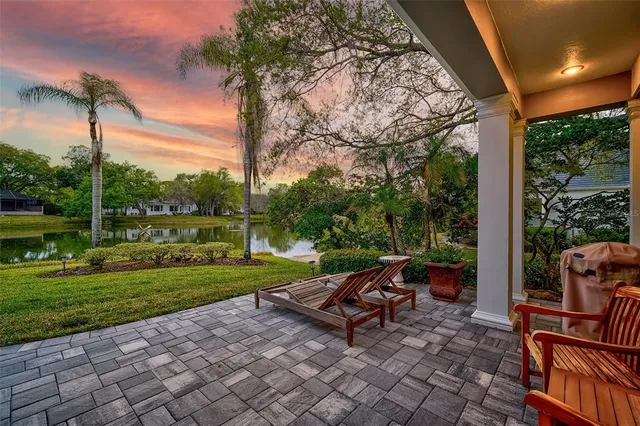a living room with fireplace furniture a rug and a chandelier