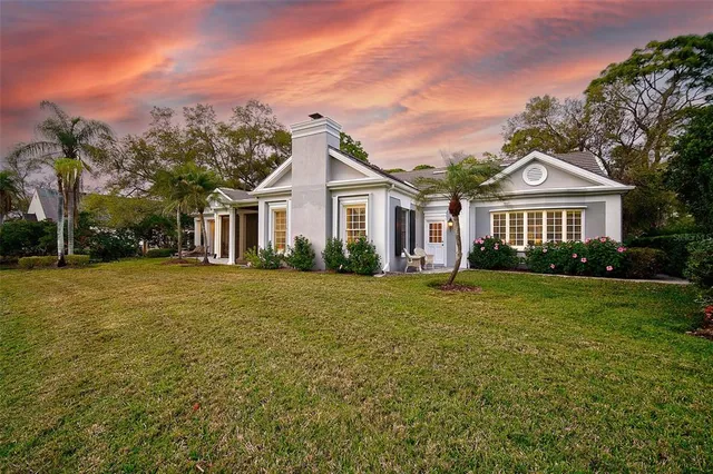 a dining room with furniture a rug and a chandelier
