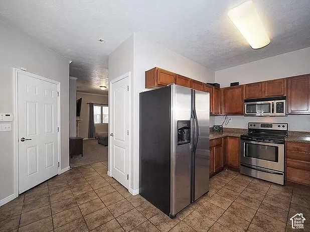 13548 South Villa Rosa Way Draper, UT 84020 - Photo 5 of 28 Kitchen featuring wood cabinetry, stainless steel appliances, and tiled flooring