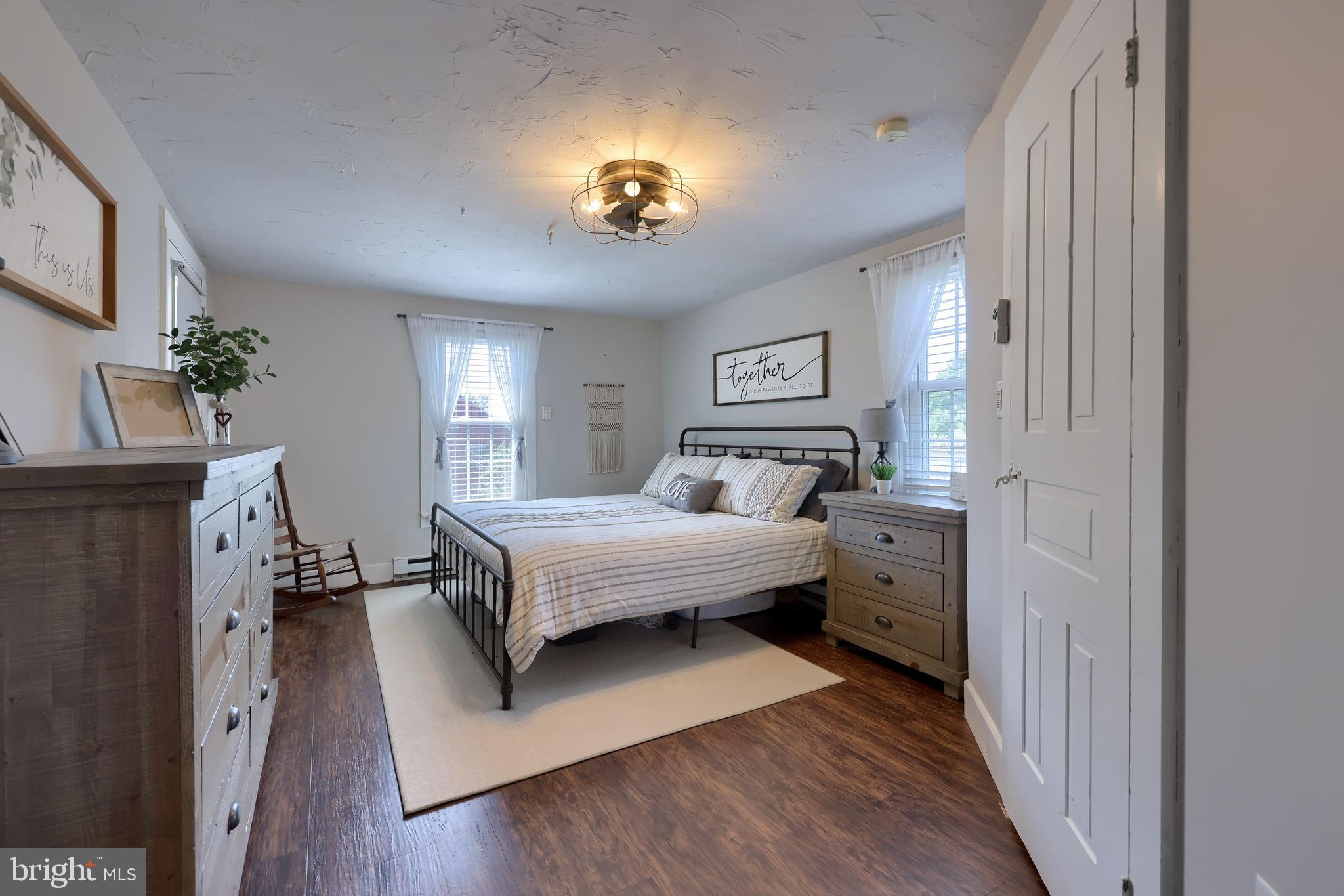 985 Smokestown Road Denver, PA 17517 - Photo 26 of 62 a spacious bedroom with a bed and a chandelier