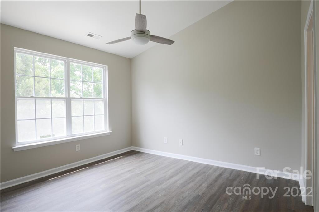 114 Chimney Rock Lane Fort Mill, SC 29708 - Photo 8 of 12 an empty room with wooden floor and windows