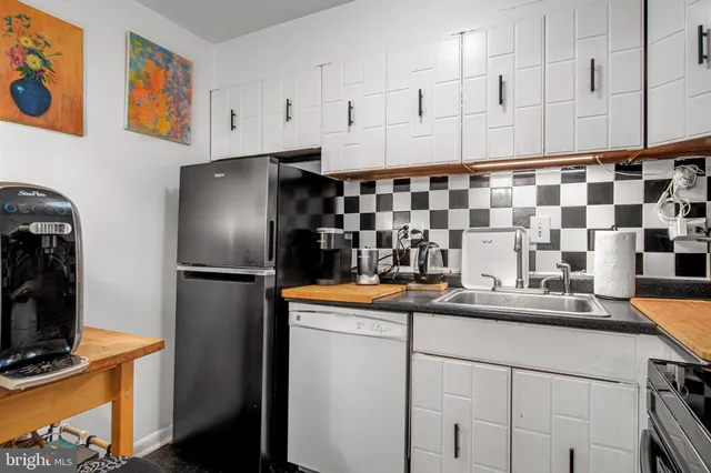 a kitchen with stainless steel appliances granite countertop a sink and a refrigerator