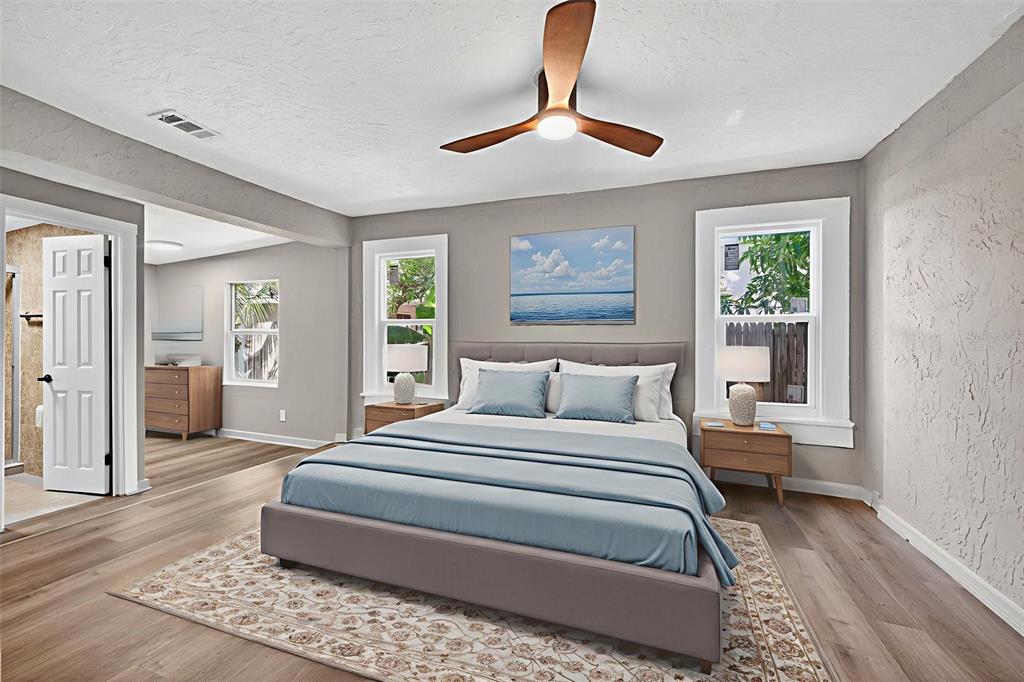 2725 14th Avenue South St. Petersburg, FL 33712 - Photo 13 of 41 a bedroom with a large bed and a chandelier