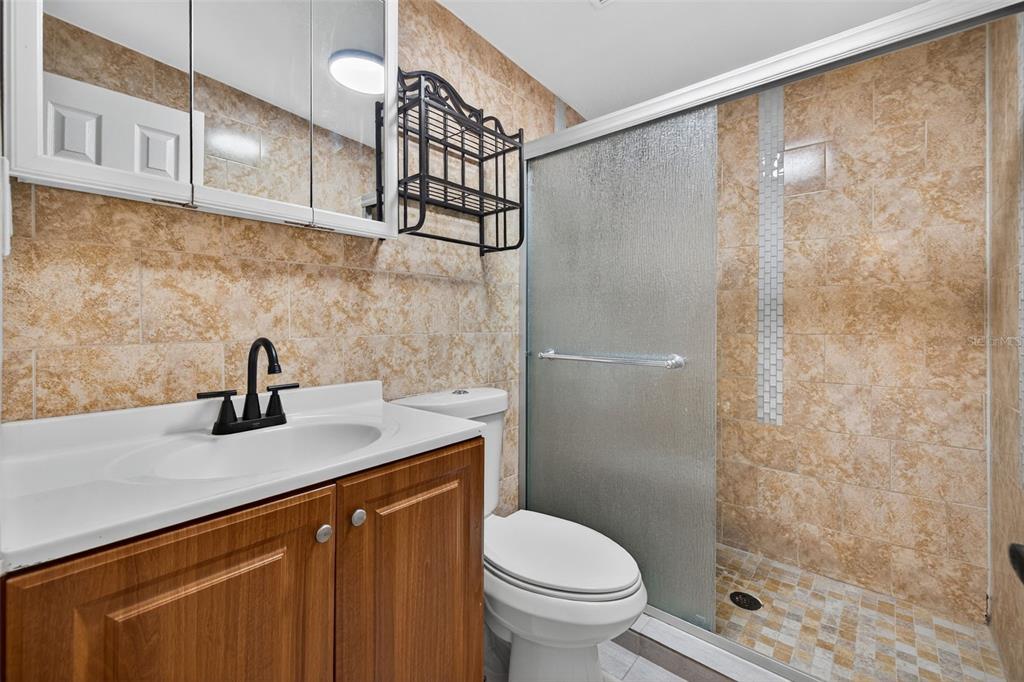 2725 14th Avenue South St. Petersburg, FL 33712 - Photo 15 of 41 a bathroom with a sink a toilet and shower