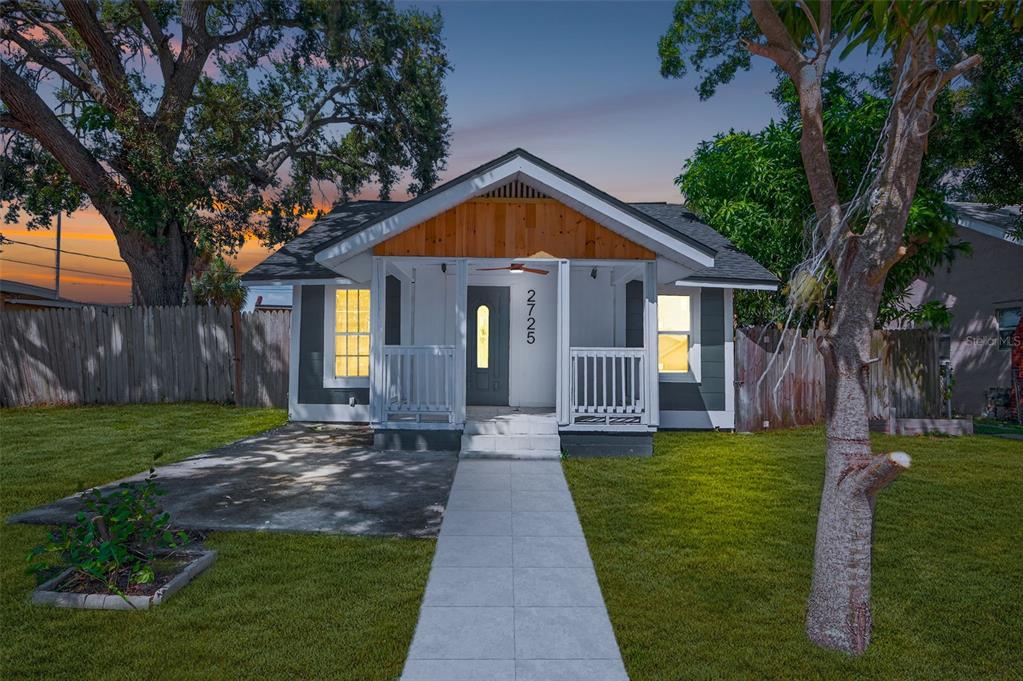2725 14th Avenue South St. Petersburg, FL 33712 - Photo 2 of 41 a view of a house with a small yard and a large tree