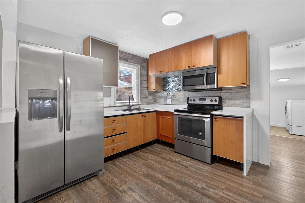 2725 14th Avenue South St. Petersburg, FL 33712 - Photo 7 of 41 a kitchen with stainless steel appliances a refrigerator sink and microwave
