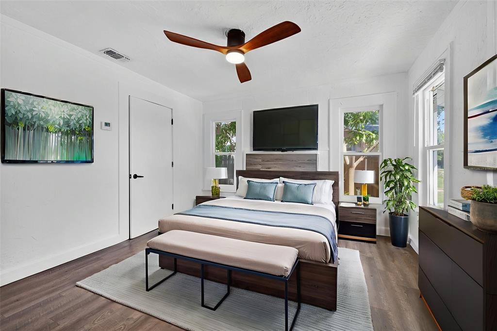 2725 14th Avenue South St. Petersburg, FL 33712 - Photo 10 of 41 a bedroom with a bed a flat screen tv and a couch