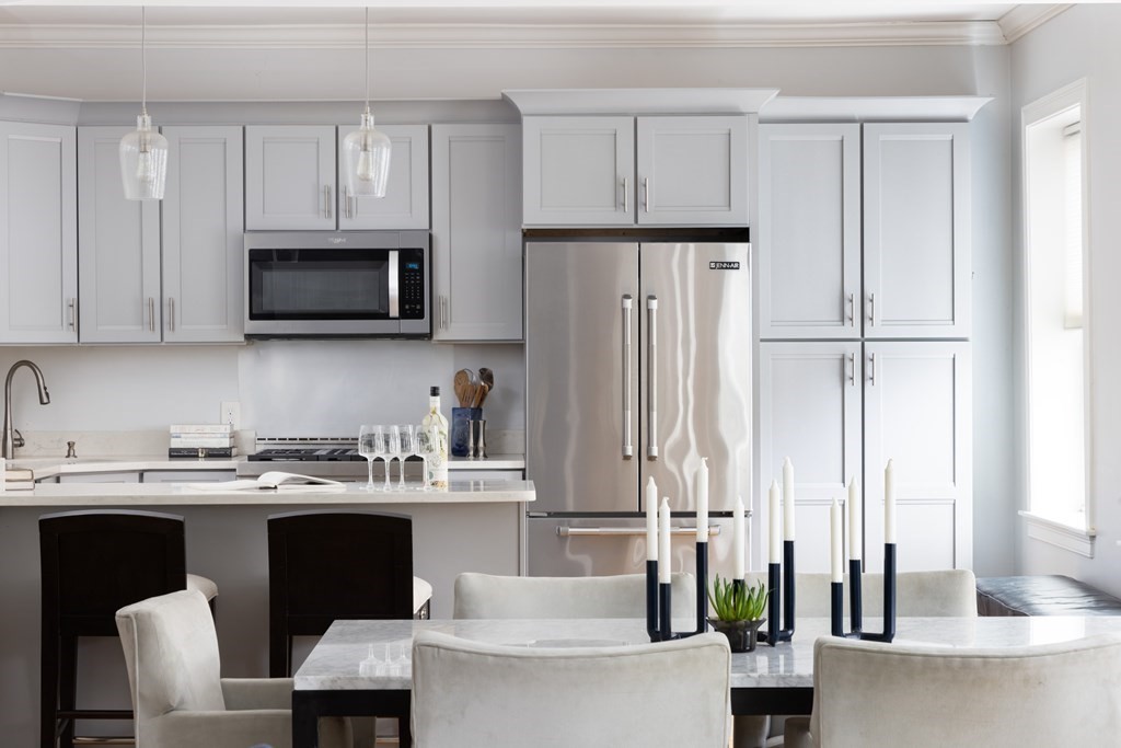 a kitchen with stainless steel appliances a stove a sink refrigerator and microwave