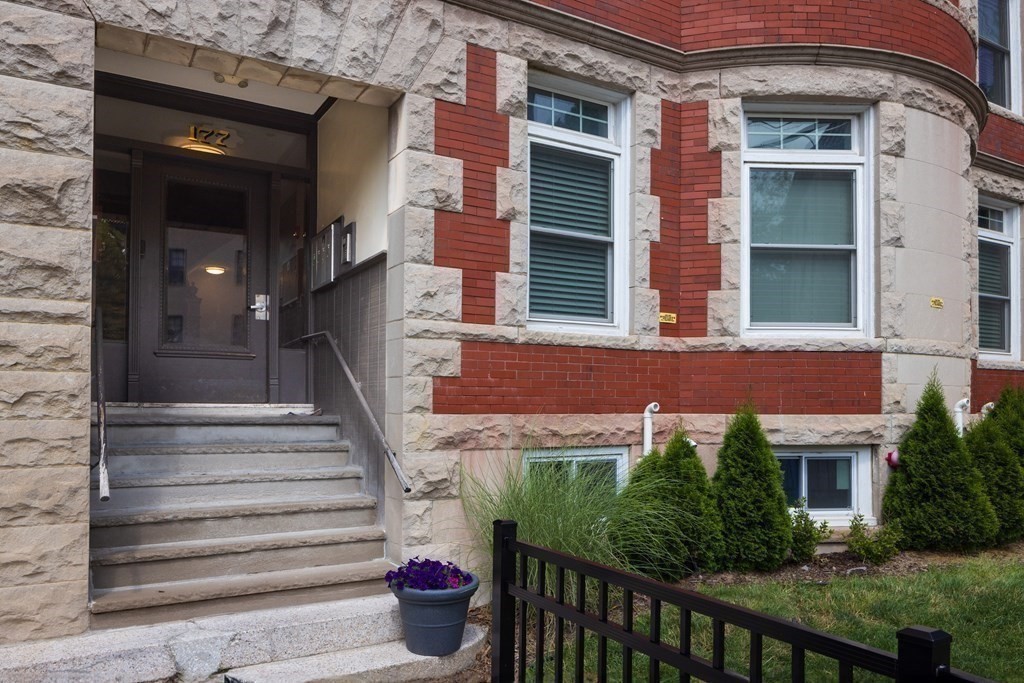 177 Winthrop Road, Unit 3 Brookline, MA 02445 - Photo 14 of 22 a view of a house with potted plants and a bench